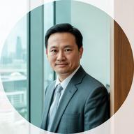 Chongchai Sonza, intellectual property lawyer, standing beside a modern office window in Singapore